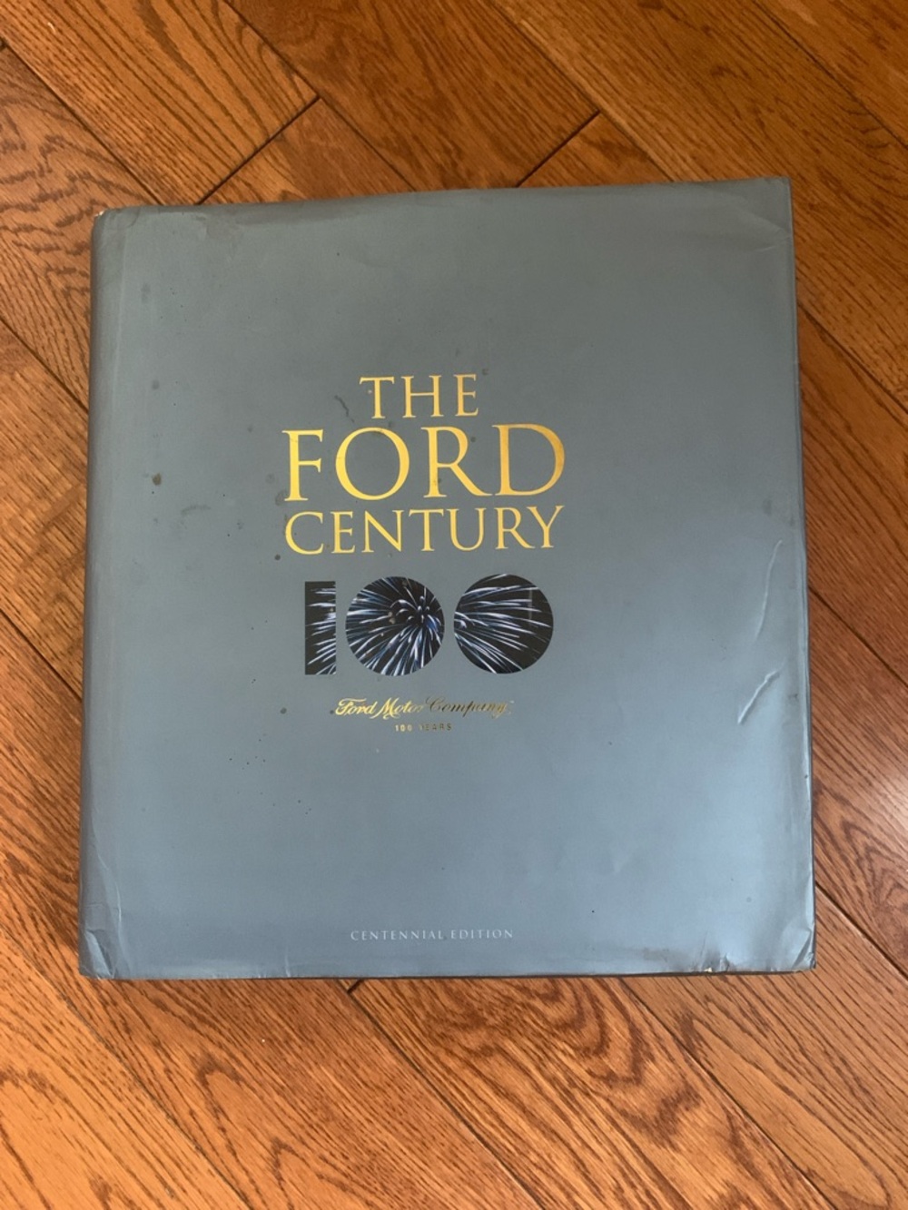 Ford hardcover book with gray cover and gold foil lettering huge coffee